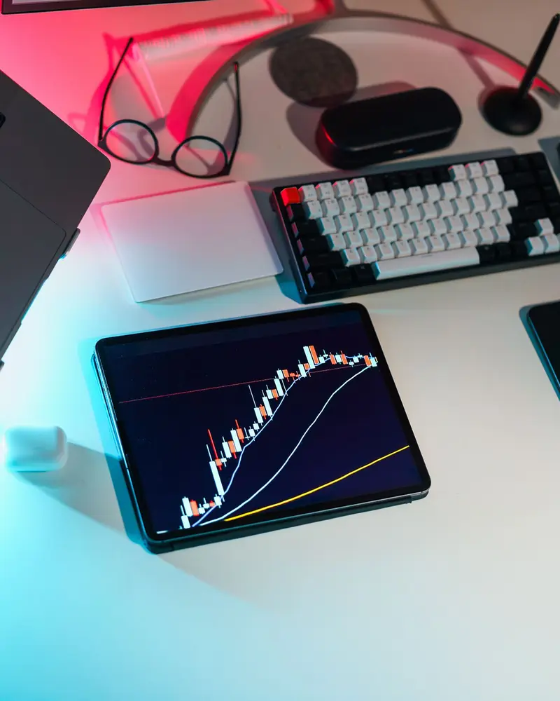 Fintech SEO agency work: a desk with a tablet showing financial charts