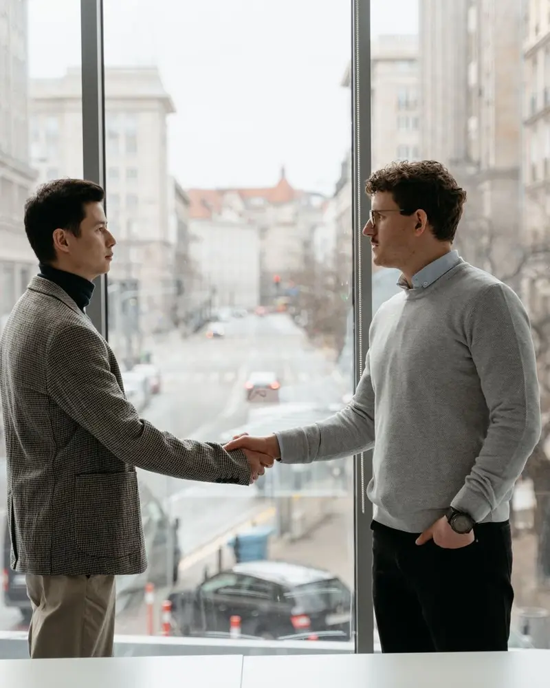 Local SEO packages: two business owners shaking hands on a deal in an office