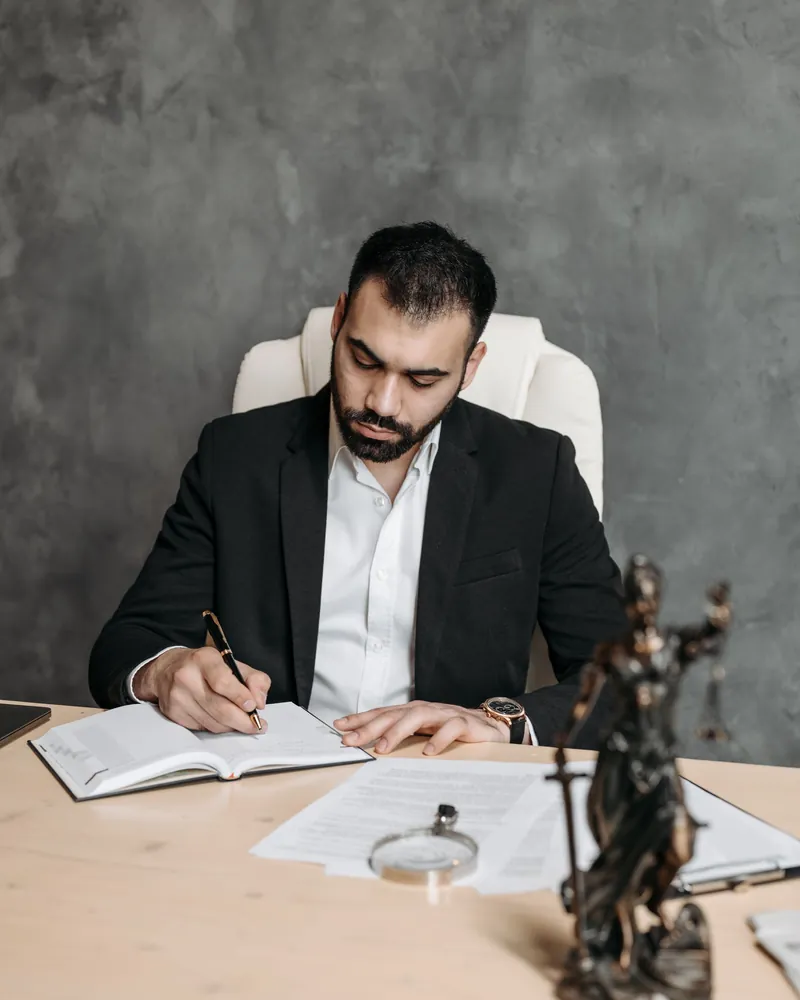 Personal injury SEO company: an attorney writing case notes at his desk