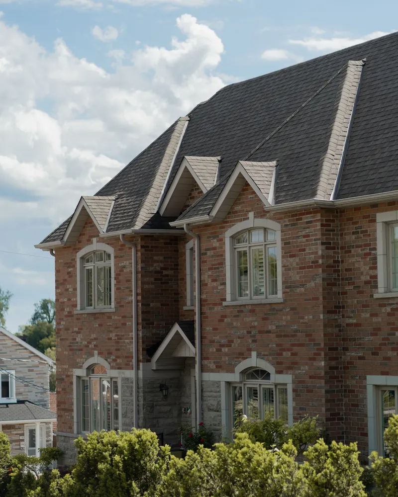 Roofing SEO company work: a brick family home with a steep shingle roof