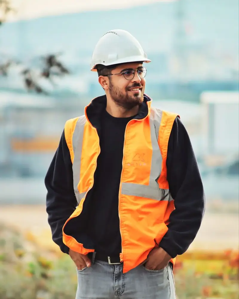 Construction company SEO work: a project manager reviewing plans on a construction site