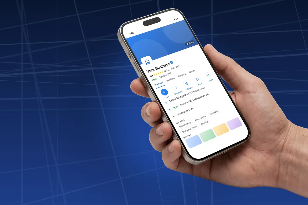 Hand holding phone showing a complete Google Business Profile with services and photos